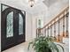 Foyer with chandelier and wrought iron front door at 335 S Satinwood Pl, Roswell, GA 30076