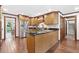 Gourmet kitchen with stainless steel refrigerator, wood floors and cabinets, and dark countertops at 335 S Satinwood Pl, Roswell, GA 30076