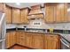 Kitchen with wood cabinets, stainless steel appliances, and stone tile backsplash at 335 S Satinwood Pl, Roswell, GA 30076