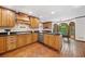 Well-lit kitchen boasting wood cabinets, stainless steel appliances, and an adjacent breakfast nook at 335 S Satinwood Pl, Roswell, GA 30076