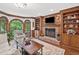 Comfortable living room with fireplace, custom built-ins and a view of the yard at 335 S Satinwood Pl, Roswell, GA 30076
