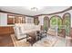 Spacious living room with a comfortable seating area, wood floors, and natural light at 335 S Satinwood Pl, Roswell, GA 30076