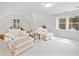 Sunlit living area features a cozy seating arrangement, plush carpeting, and bright windows at 335 S Satinwood Pl, Roswell, GA 30076