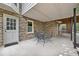 Covered brick patio with a wrought iron table and chairs, perfect for outdoor dining at 335 S Satinwood Pl, Roswell, GA 30076