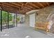 Covered patio with brick accents and a comfortable seating area at 335 S Satinwood Pl, Roswell, GA 30076