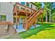 Grassy backyard with stairway to deck and two-story home at 5121 Hope Sw Ct, Lilburn, GA 30047