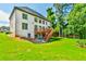 A beautiful multi-story home boasts a spacious backyard and a wooden deck at 5121 Hope Sw Ct, Lilburn, GA 30047