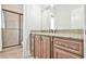 Bathroom featuring a tiled shower and granite vanity with custom cabinets and vintage hardware at 5121 Hope Sw Ct, Lilburn, GA 30047