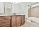 This spacious bathroom offers a granite vanity with custom cabinets and a tiled tub-shower combo at 5121 Hope Sw Ct, Lilburn, GA 30047