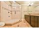 This bathroom includes a large shower with a glass door, a vanity, and tile floors at 5121 Hope Sw Ct, Lilburn, GA 30047
