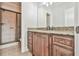 Bathroom featuring a tiled shower and granite vanity with custom cabinets and vintage hardware at 5121 Hope Sw Ct, Lilburn, GA 30047