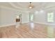 Large bedroom with hardwood floors, tray ceiling, and natural light offering a relaxing and airy space at 5121 Hope Sw Ct, Lilburn, GA 30047