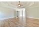 Large bedroom with hardwood floors, tray ceiling, and natural light offering a relaxing and airy space at 5121 Hope Sw Ct, Lilburn, GA 30047