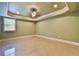 Bedroom with tan carpet, a window, and ceiling fan at 5121 Hope Sw Ct, Lilburn, GA 30047