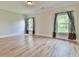 This airy bedroom features gleaming hardwood floors and plenty of natural light through large windows at 5121 Hope Sw Ct, Lilburn, GA 30047