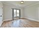 Bedroom with hardwood floors, white walls, and window with curtains at 5121 Hope Sw Ct, Lilburn, GA 30047