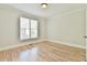 Bedroom with hardwood floors, white walls, and a large window at 5121 Hope Sw Ct, Lilburn, GA 30047