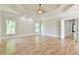 Large bedroom with hardwood floors, tray ceiling, and natural light offering a relaxing and airy space at 5121 Hope Sw Ct, Lilburn, GA 30047