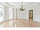 Dining room with hardwood floors, crown molding, and an elegant chandelier at 5121 Hope Sw Ct, Lilburn, GA 30047
