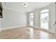 Bright, empty room with hardwood floors, two arched windows, and crown molding at 5121 Hope Sw Ct, Lilburn, GA 30047