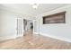 Neutral room with hardwood floors, a built-in bookshelf, and double doors leading to the living room at 5121 Hope Sw Ct, Lilburn, GA 30047