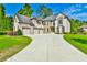 Elegant brick home with a three-car garage and a large, beautifully landscaped front yard at 5121 Hope Sw Ct, Lilburn, GA 30047