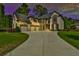 Beautiful estate home boasts multi-car garage, stone accents, and manicured lawn at 5121 Hope Sw Ct, Lilburn, GA 30047