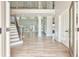Grand foyer with hardwood floors, a staircase, and a view into the spacious living area at 5121 Hope Sw Ct, Lilburn, GA 30047