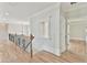 Hallway with hardwood floors and a decorative railing at 5121 Hope Sw Ct, Lilburn, GA 30047