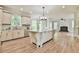 Kitchen with hardwood floors, large island, custom cabinets, granite countertops, and stainless steel appliances at 5121 Hope Sw Ct, Lilburn, GA 30047