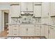 Kitchen with custom cabinets and granite backsplash at 5121 Hope Sw Ct, Lilburn, GA 30047