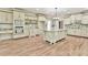 Gourmet kitchen featuring custom cabinets, granite countertops, center island, and modern appliances at 5121 Hope Sw Ct, Lilburn, GA 30047