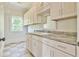Bright laundry room with plenty of cabinet space and a sink, offering convenience and functionality at 5121 Hope Sw Ct, Lilburn, GA 30047