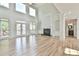 Bright living room features large windows, hardwood floors, fireplace, and built-in bookshelves at 5121 Hope Sw Ct, Lilburn, GA 30047