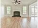 Comfortable living area with fireplace, hardwood floors, and ceiling fan provides plenty of light at 5121 Hope Sw Ct, Lilburn, GA 30047