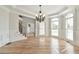 Spacious living room with hardwood floors, detailed molding, and large windows providing natural light at 5121 Hope Sw Ct, Lilburn, GA 30047