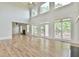 Expansive living room with fireplace, high ceilings, many windows and access to the outdoor deck at 5121 Hope Sw Ct, Lilburn, GA 30047