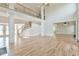 Open-concept living room with soaring ceilings, prominent columns, staircase, and ample natural light at 5121 Hope Sw Ct, Lilburn, GA 30047