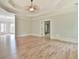 This main bedroom features hardwood floors, a tray ceiling, and an ensuite bathroom at 5121 Hope Sw Ct, Lilburn, GA 30047