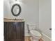 Powder room with a dark wood vanity and toilet at 5121 Hope Sw Ct, Lilburn, GA 30047