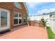 Brick patio with a stainless grill and white privacy fence, perfect for outdoor entertaining at 5250 Villa Lake Ct, Suwanee, GA 30024
