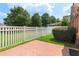 Well-maintained backyard featuring a white fence, manicured lawn, and mature landscaping at 5250 Villa Lake Ct, Suwanee, GA 30024