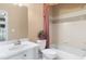 Traditional bathroom with a white vanity, toilet, tub, and decorative shower curtain at 5250 Villa Lake Ct, Suwanee, GA 30024