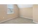 Cozy bedroom with a large window, carpeted floors, and ample natural light at 5250 Villa Lake Ct, Suwanee, GA 30024