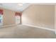 Spacious carpeted bedroom featuring vaulted ceiling and large windows with natural light at 5250 Villa Lake Ct, Suwanee, GA 30024