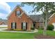 Charming brick home with black shutters, manicured lawn, and mature landscaping at 5250 Villa Lake Ct, Suwanee, GA 30024