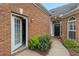 Brick home's exterior with a view of the front door and sidelight windows at 5250 Villa Lake Ct, Suwanee, GA 30024