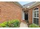 Brick exterior close up, showcasing a decorative front door with sidelights at 5250 Villa Lake Ct, Suwanee, GA 30024