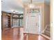 Foyer featuring hardwood floors, staircase, built-in bookshelf, and a chandelier at 5250 Villa Lake Ct, Suwanee, GA 30024