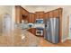 Well-equipped kitchen featuring granite countertops, stainless steel appliances, and wooden cabinetry at 5250 Villa Lake Ct, Suwanee, GA 30024